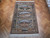 7x10 Tabriz pictorial rug laid on herringbone parquet floor showing brown borders and ivory fringe