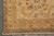Corner detail of golden beige border with arabesques, flowerheads and tightly wrapped selvage