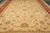 Beige field filled with gold, coral and sage palmettes in an all-over floral layout