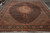 Oversize 12x17 Tabriz rug laid flat on warehouse floor showing ivory fringe and full design
