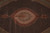 Close-up of the layered concentric medallion in rust, copper and beige with fine silk highlights
