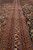 Border stripes in rust, ivory and blue with boteh paisley motifs photographed at a low angle