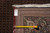 Back of the rug with original tag reading 11-6 x 16-6 beside a tape measure