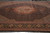 Rust and salmon scalloped medallion anchoring the black fish pattern field and palmette main border