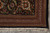 Corner detail with black ground border, floral palmettes, guard stripes and clean ivory cotton fringe