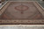 Angled floor shot of oversize wool and silk Tabriz rug with cream fringe and wide border