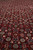 Macro of the all over Herati fish pattern in ivory, teal and rose on ruby wool pile