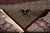 Rug folded back to reveal the dense hand-knotted weave, cotton fringe and reverse pattern clarity