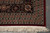 Corner detail with black border rosettes, layered guard stripes and hand-finished ivory cotton fringe