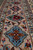 Rose pink main border detail with turquoise rosettes, navy lozenges and light blue floral cartouches