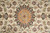 Detail of the salmon and gold rosette medallion with fine knotting and silk outlined floral vines