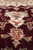 Macro of burgundy pile showing silk highlighted rose blossoms and ivory pendant motif