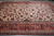 12' x 17'7" Persian Isfahan rug photographed on warehouse floor showing ivory field and red border