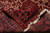 Rug folded back to reveal the tight hand-knotted wool weave and white cotton fringe