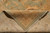 Folded corner showing the flat even back, cotton foundation and ivory fringe of the rug