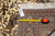 Back tag and tape measure confirming the 6 feet 8 inch width of this handmade rug