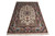 Full angled view of hand-knotted 5' x 7'10" Isfahan rug showing ivory field and pink border roses
