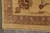 Detail of the mauve main border, gold guard stripe and hand-tied fringe on ivory wool