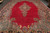 Oversize 13x21 Kerman rug on display, central navy medallion floating on an open rose red ground