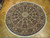 10' x 10'3" round Oriental rug displayed on parquet floor showing full dome design and fringe