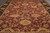 Angled floor view of the oversize 12x17 wool rug with olive green and camel florals