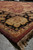 Low angle along the burgundy selvage and fringe of this large Jaipur hand-knotted wool rug
