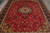 Gold spandrel corners and woven bird figures scattered across the red field of this Tabriz