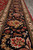 Black main border close-up with salmon palmettes, ivory guard stripes and green vine minor band
