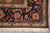 Corner detail with hand-tied ivory fringe, red selvage and blossoming dark border scrollwork