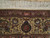 Close-up of rose border with small woven signature cartouche and camel palmette guard stripe detail