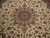 Detail of ivory field with fine floral vines and a rose medallion at 400 knots per square inch
