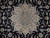 Close-up of the ivory star medallion with light blue petals and curling navy arabesque vines