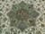 Close-up of the green 8 petal medallion with brown, turquoise and coral floral motifs