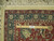 Back of the 10x14 rug with ruler showing hand-knotted density on cotton foundation