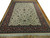 10' x 14' ivory wool rug angled across hardwood, showing red border and clean fringe