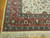 Corner detail of brick red main border, green guard bands and soft wool pile