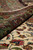 Rolled edge revealing plush wool and silk pile depth next to the ivory floral field