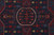 Close up of ivory outlined center medallion with red tribal flowers on deep indigo ground