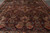 Close overhead angle showing salmon palmettes, navy vines and burgundy ground of this hand-knotted wool rug
