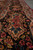 Close view of black main border with pink roses, turquoise blossoms and salmon cartouche panels