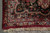 Corner detail with ivory hand-knotted fringe, burgundy outer band and floral guard stripes