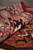 Rolled edge close-up showing thick wool pile, slate blue border band and terracotta guard stripes