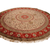 Ivory and red 10' x 10' round silk rug on white, full Tabriz medallion design visible