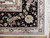 Corner detail showing black main border, mauve guard stripe and ivory fringe on wool silk rug