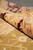 Rolled edge showing burgundy border reverse and even hand-knotted foundation of this Indian rug