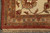 Corner detail of ivory main border with brick red, gold and sky blue floral motifs
