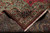 Folded back corner revealing cotton foundation, knot density and green spandrel wool pile detail