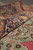 Rolled edge close-up showing navy paisley border and soft green field wool pile texture