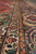 Cream guard border and navy palmette band photographed along the length of this Tabriz rug