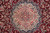 Cream and rose central medallion outlined in navy, framed by dense burgundy floral field detail
